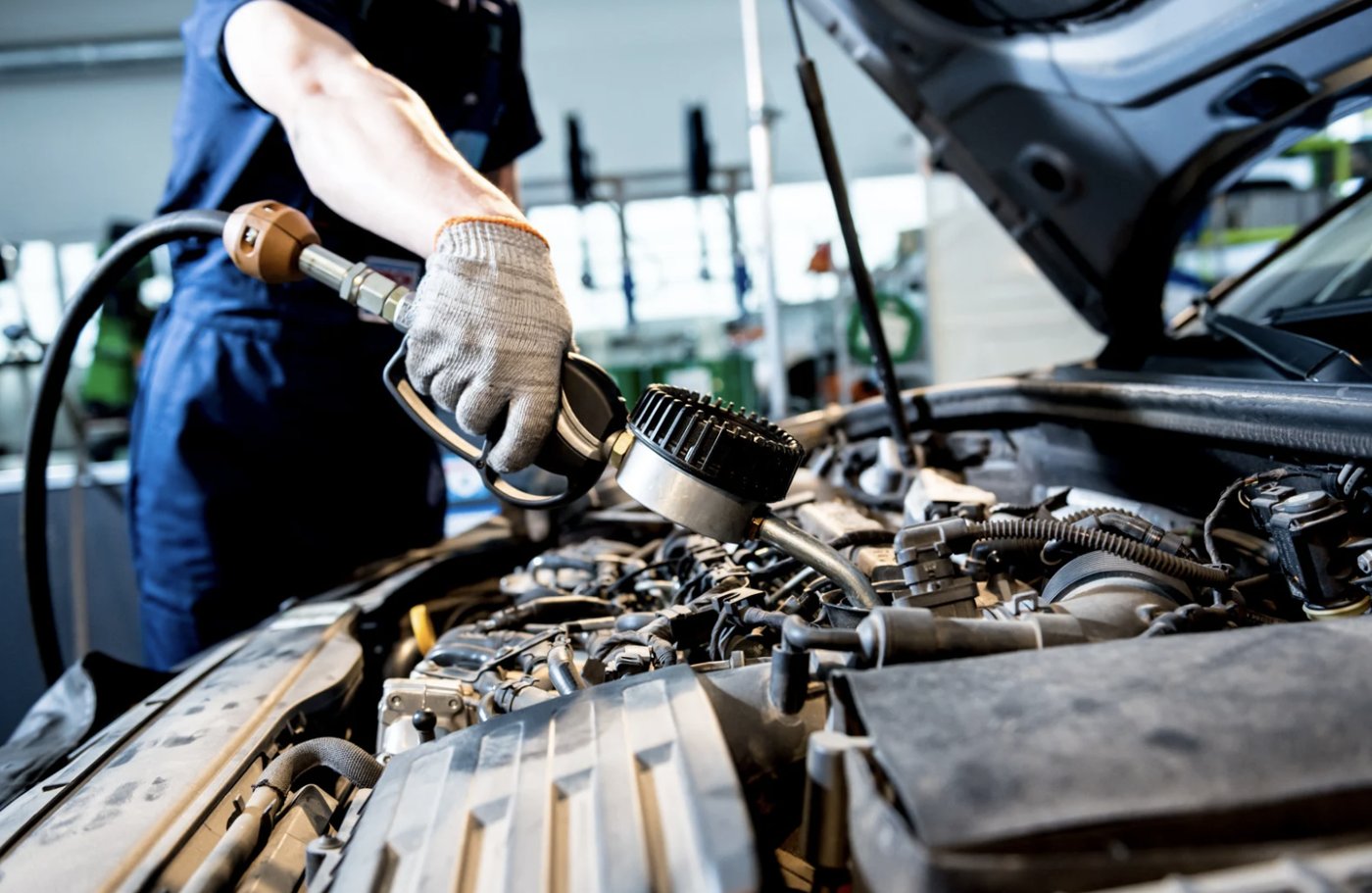Fresh motor oil being poured into an engine during scheduled maintenance.
