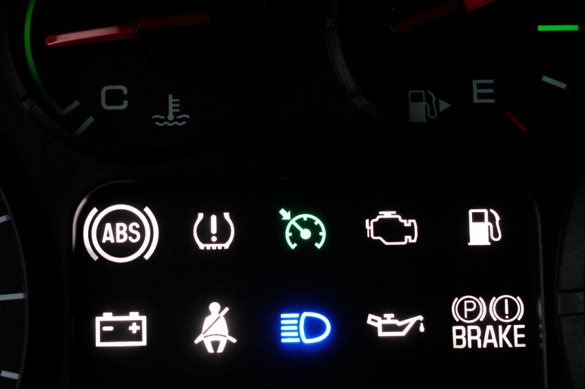 Close-up of a vehicle dashboard showing various illuminated indicator lights