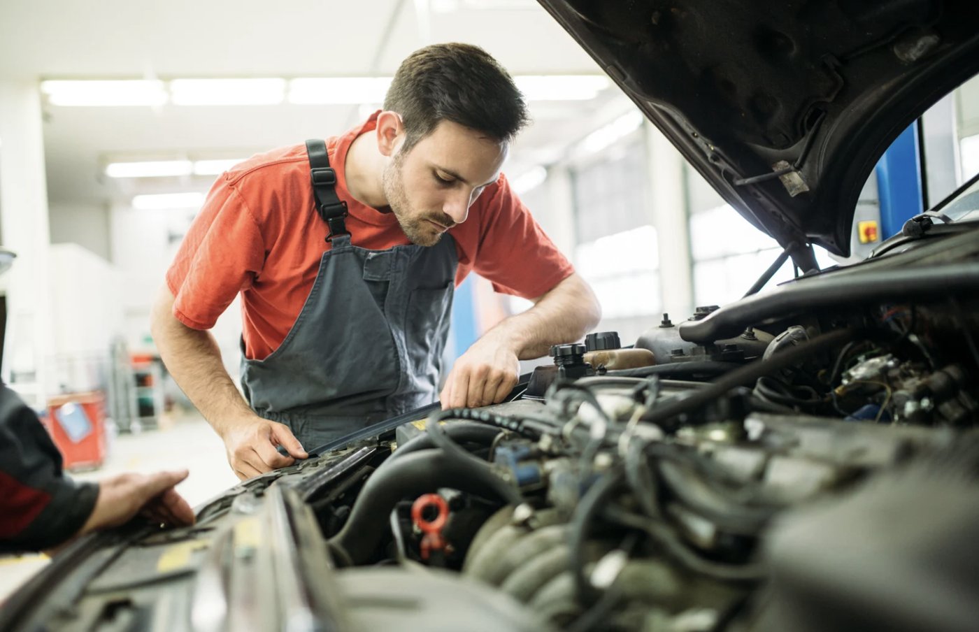 Driver reviewing the owner's manual to check the recommended oil change interval.