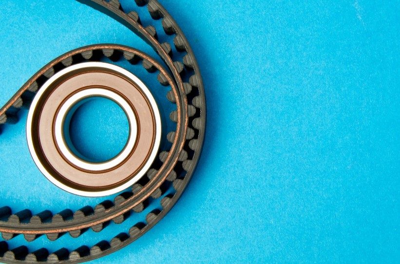 A timing belt wrapped around a metal pulley