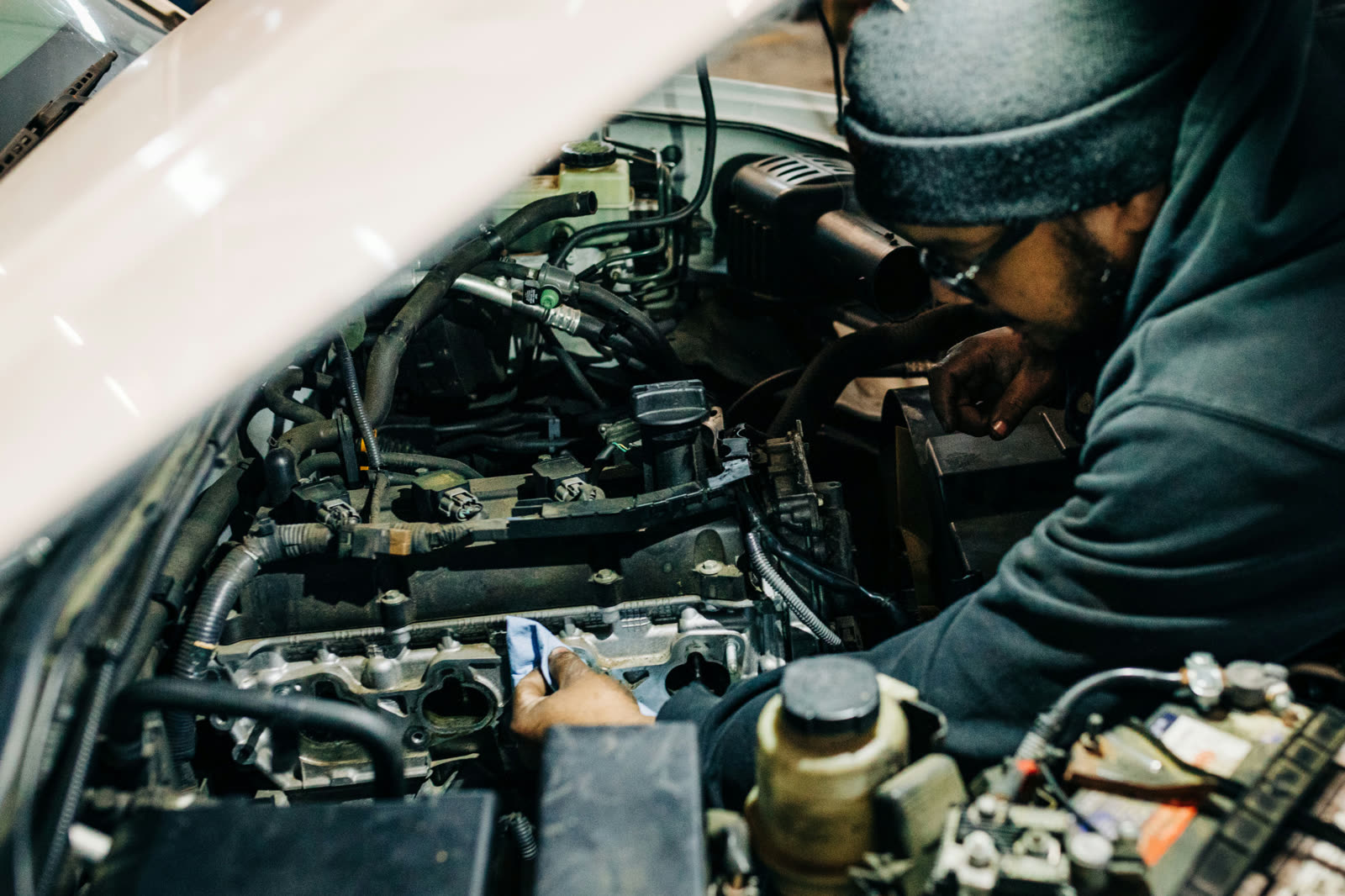 ASE-certified technician performing an engine check-up