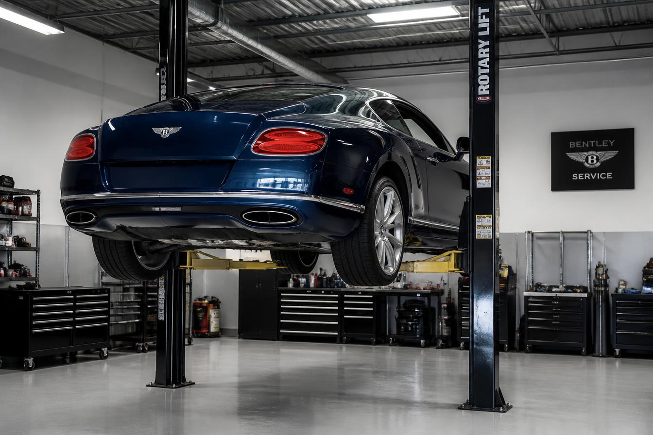 Dark blue Bentley Continental GT raised on a service lift in a modern repair shop