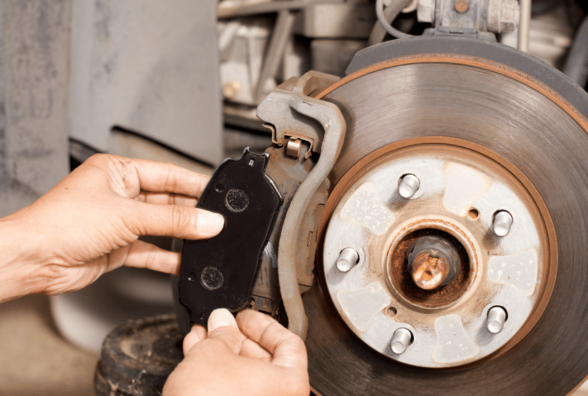 Blue Ridge Automotive | Atlanta Brake Services: Types, Signs, and Repair Options Technician installing a new brake pad as part of a standard brake repair process.
