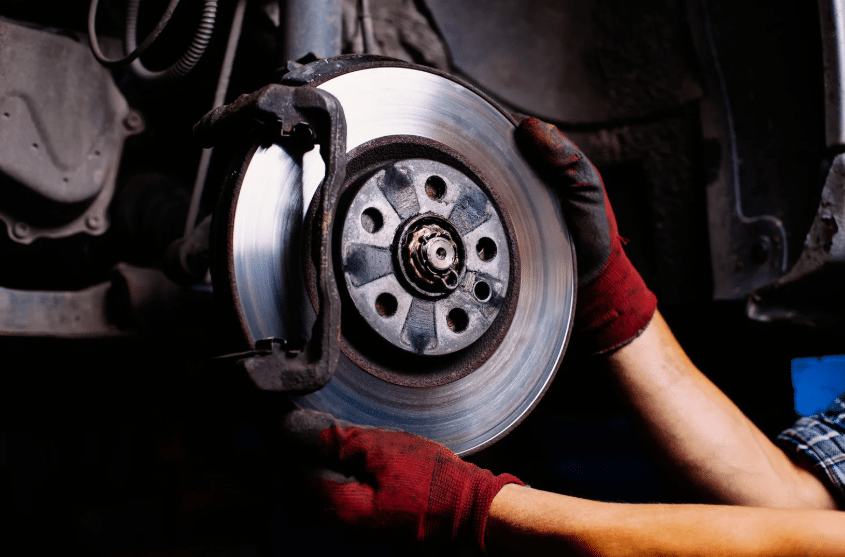 Blue Ridge Automotive | Atlanta Brake Services: Types, Signs, and Repair Options Hands holding a brake rotor during a brake repair inspection and replacement job.