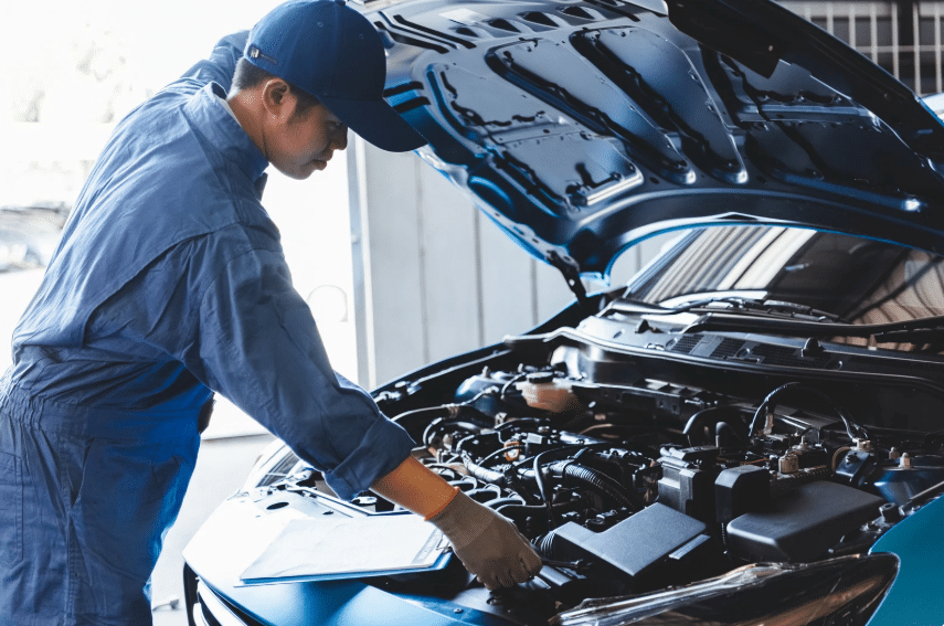 Blue Ridge Automotive | How Driving in a Stop-and-Go Traffic Affects Your Car Auto mechanic performing an engine check to ensure vehicle reliability in stop and go traffic.