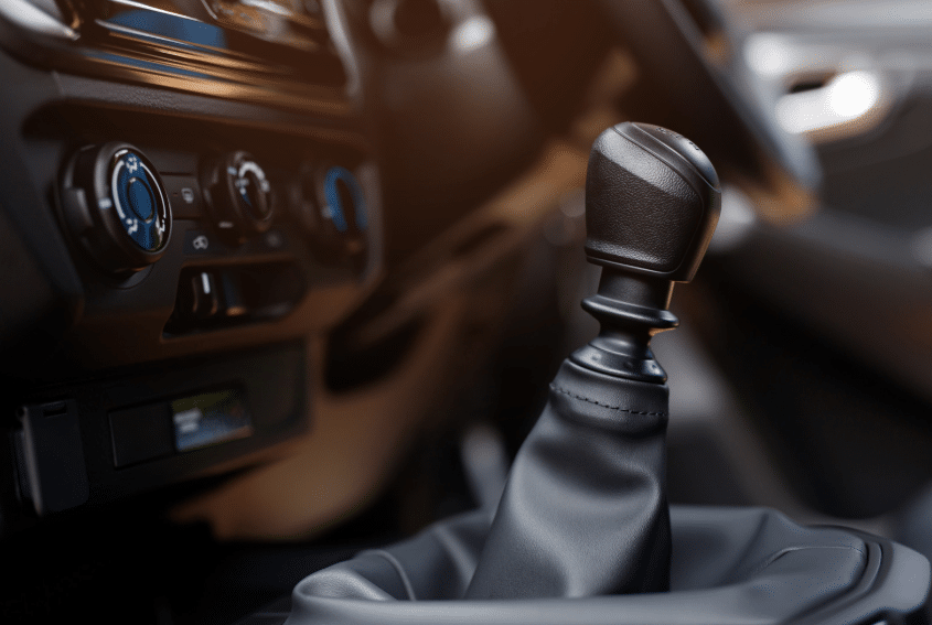 Blue Ridge Automotive | How Transmission Maintenance Keeps Your Vehicle Running Longer Close-up of a manual gear shift lever inside a vehicle, highlighting the importance of regular transmission maintenance.